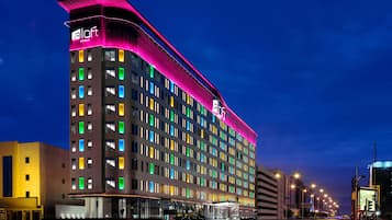 Experience the unique architectural design of this hotel, featuring a curved facade and multi-storied structure with numerous windows.