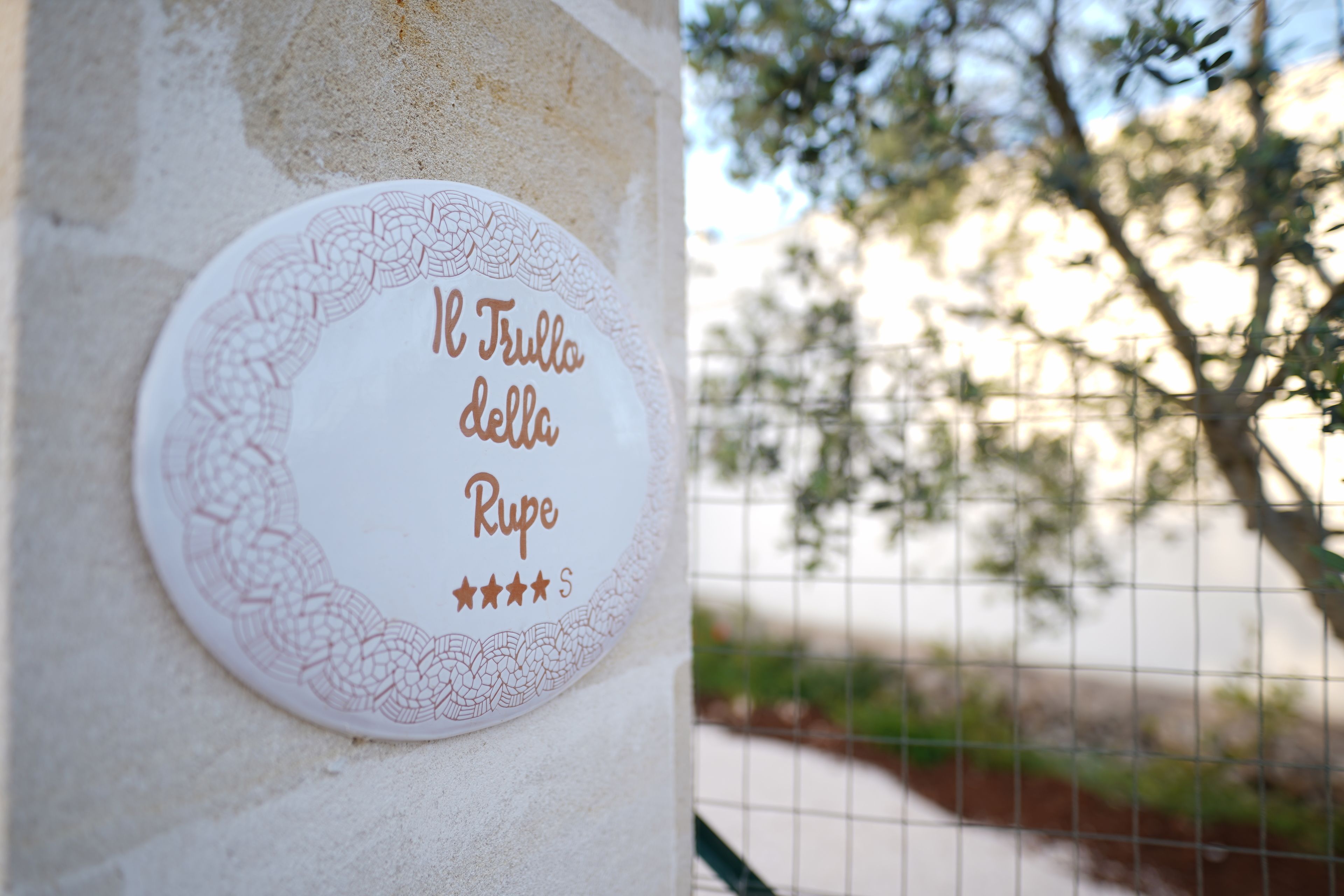 A wall plaque with a decorative border and text.