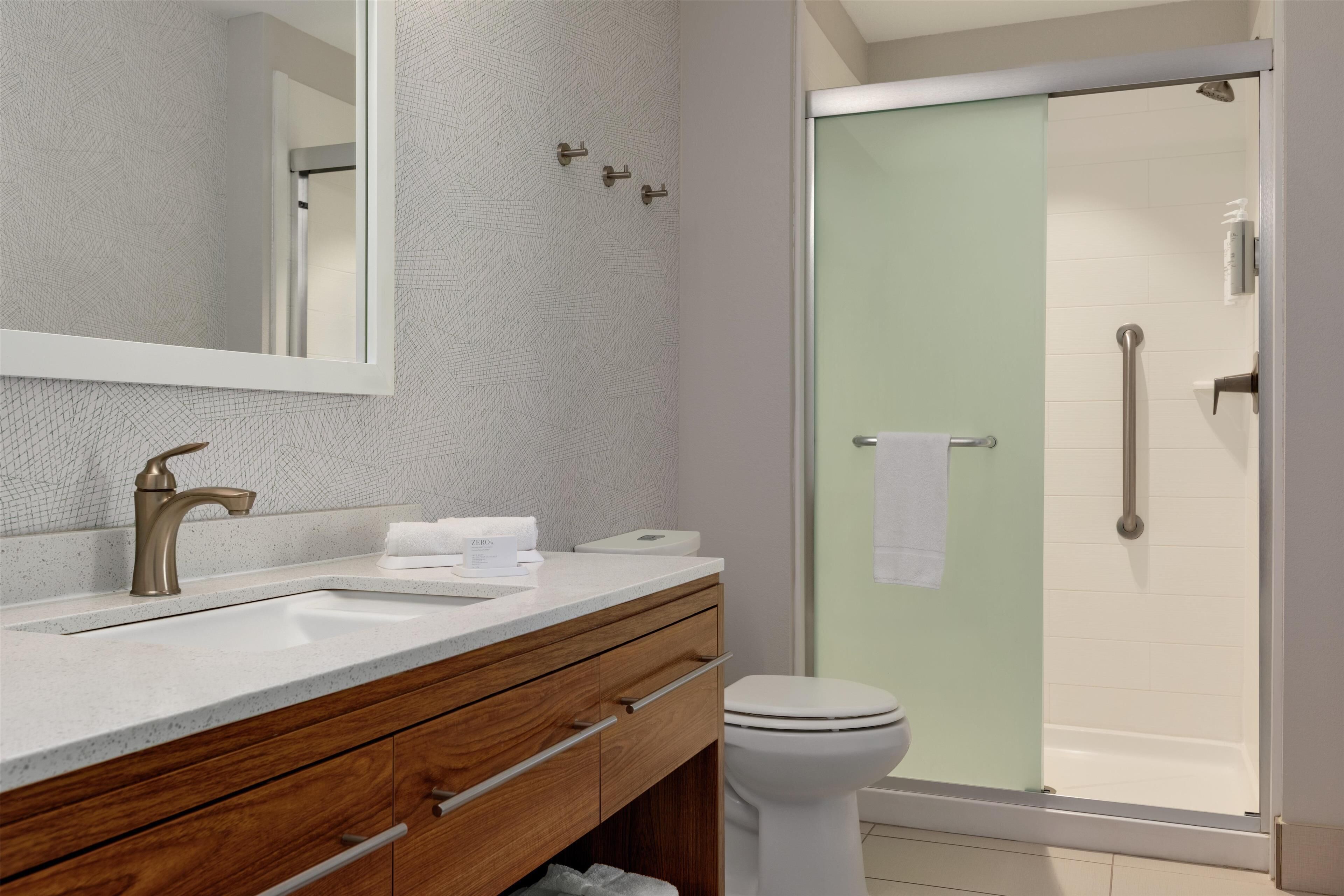 A bathroom with a sink, mirror, and toilet.