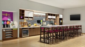 A modern cafe with a bar area, a coffee machine, and a sign reading "inspired table." - Home2 Suites by Hilton Houston Energy Corridor (Houston)