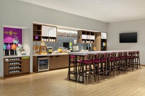 A modern cafe with a bar area, a coffee machine, and a sign reading "inspired table." - Home2 Suites by Hilton Houston Energy Corridor (Houston)
