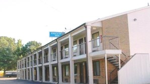 A motel with a central corridor and individual rooms on either side. - Executive Inn (West Columbia)