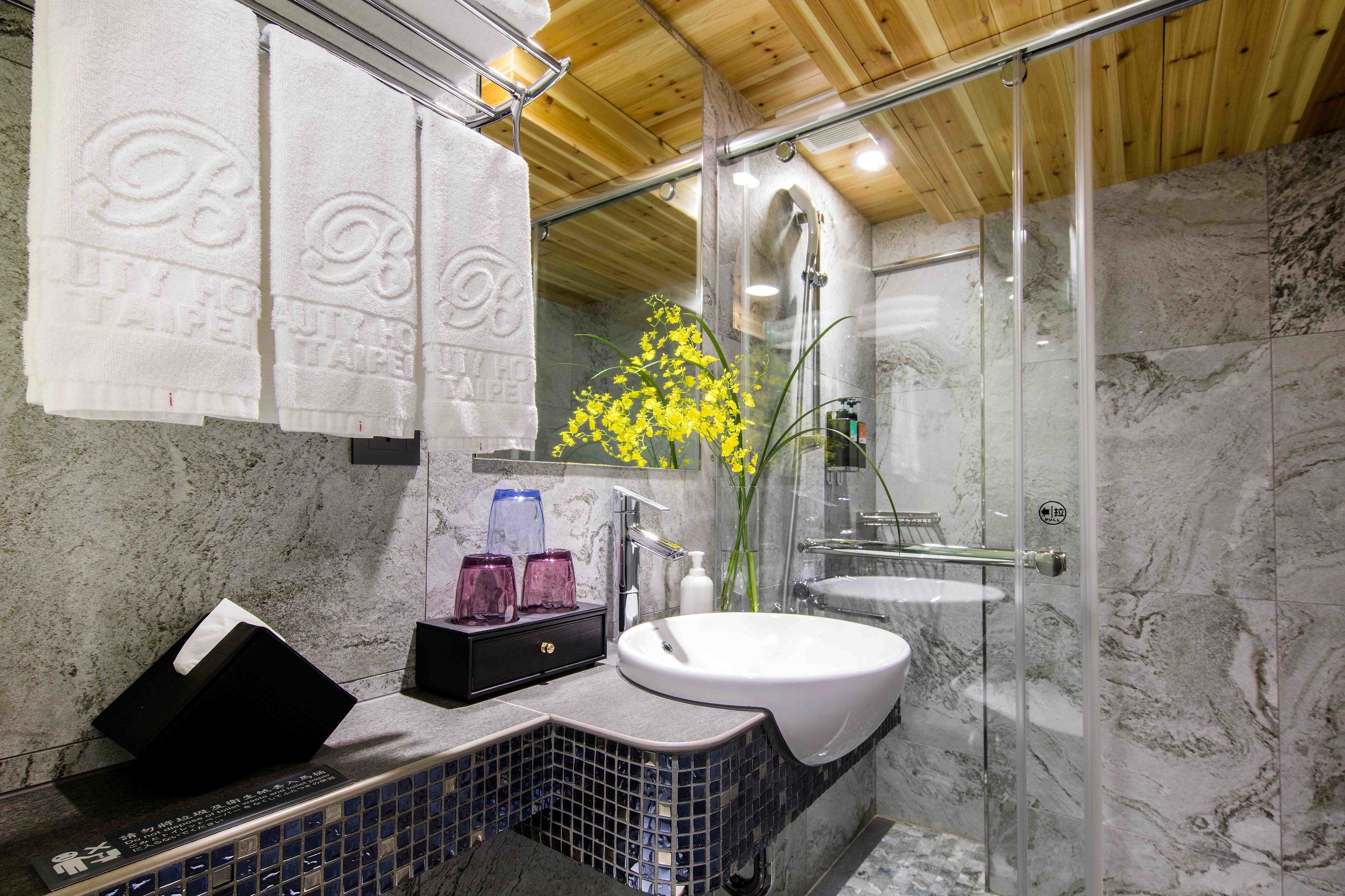 deluxe triple room | bathroom | rainfall showerhead, hair dryer, slippers, electronic bidet