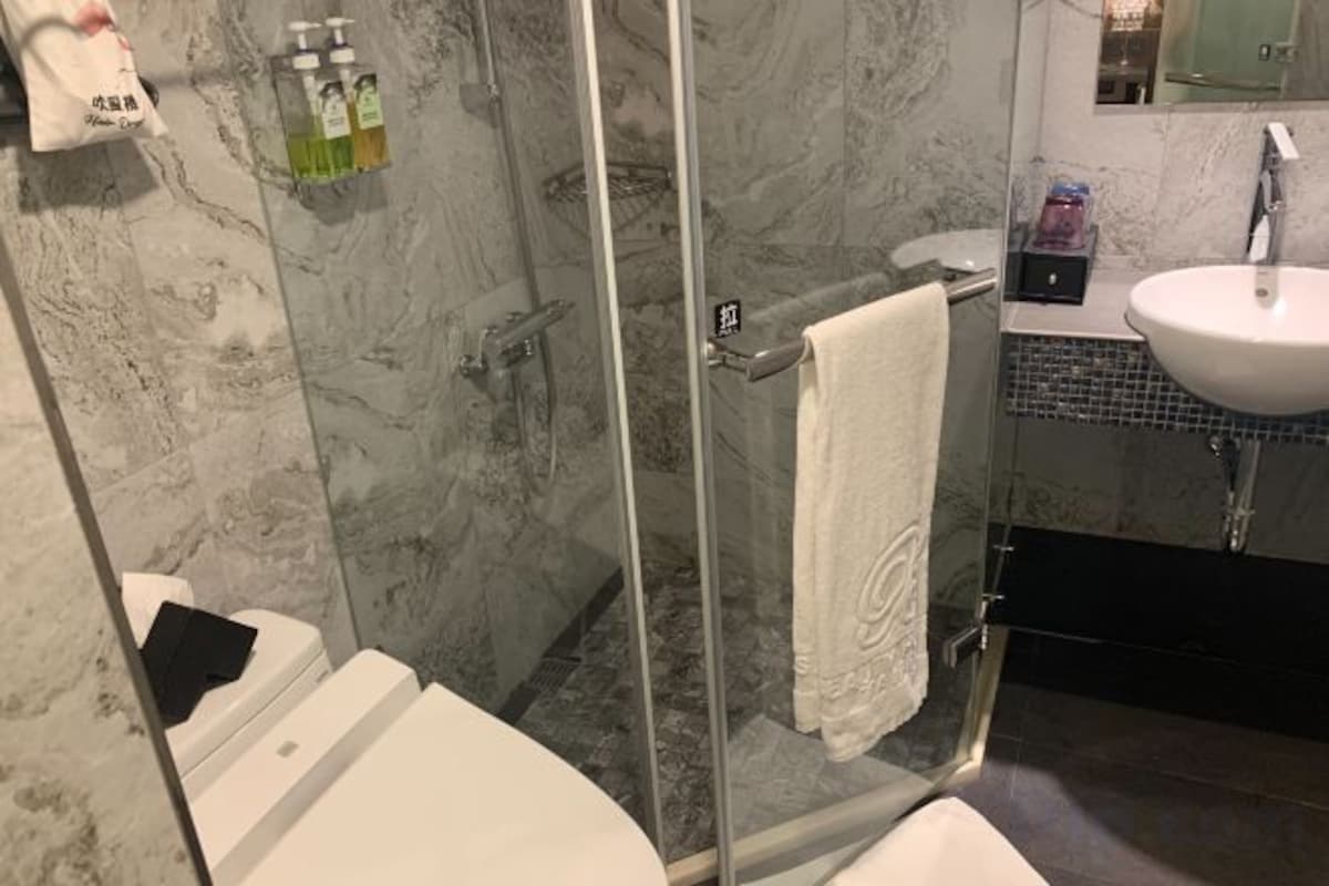 Bathroom | Rainfall showerhead, hair dryer, slippers, electronic bidet