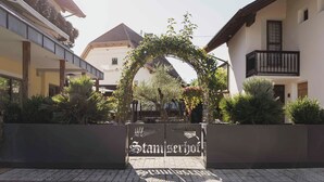 A gated entrance with a sign reading 'Stamserhof.' - Hotel Stamserhof (Andriano)