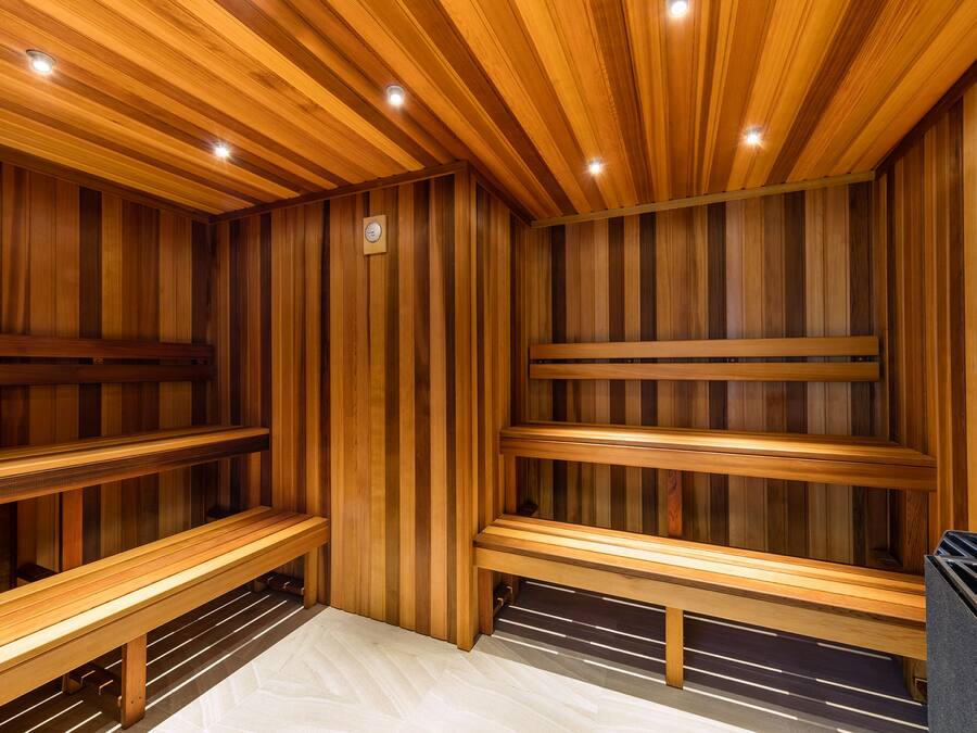 A sauna with wooden benches and a tiled floor.