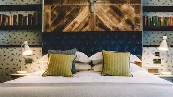 A bed with a wooden headboard, two bedside lamps, and two pillows.