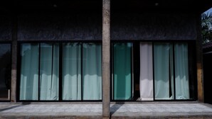 A building with large windows and a concrete staircase leading to the entrance. - 88 Fine Hotel (Phunphin)