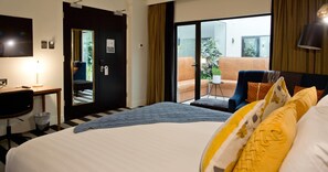 A hotel room with a bed, a desk, a chair, a TV, and a balcony with a view. - The Ellen Hotel, an Ascend Collection Hotel (Port Pirie)