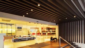 A modern interior with a staircase leading to a glass storefront.