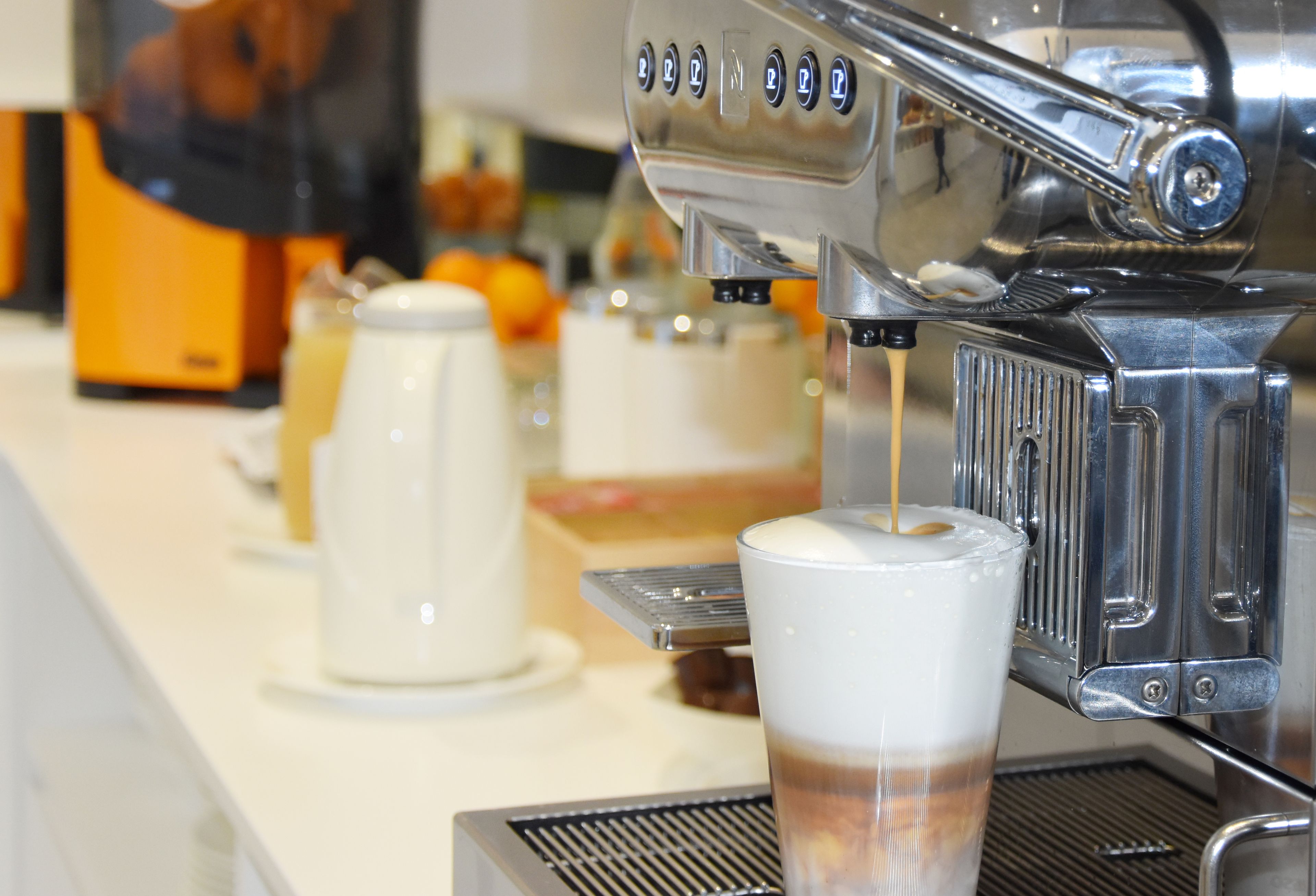 A coffee machine dispensing coffee into a cup.