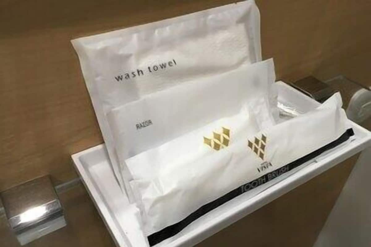 A white tray with two white towels labeled 'wash towel' and 'bath towel' in a hotel setting.