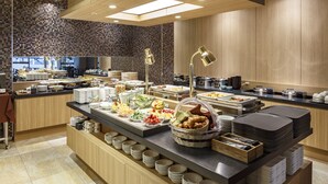 A buffet setup with various food items and utensils. - Hotel Vista Sendai (Sendai)