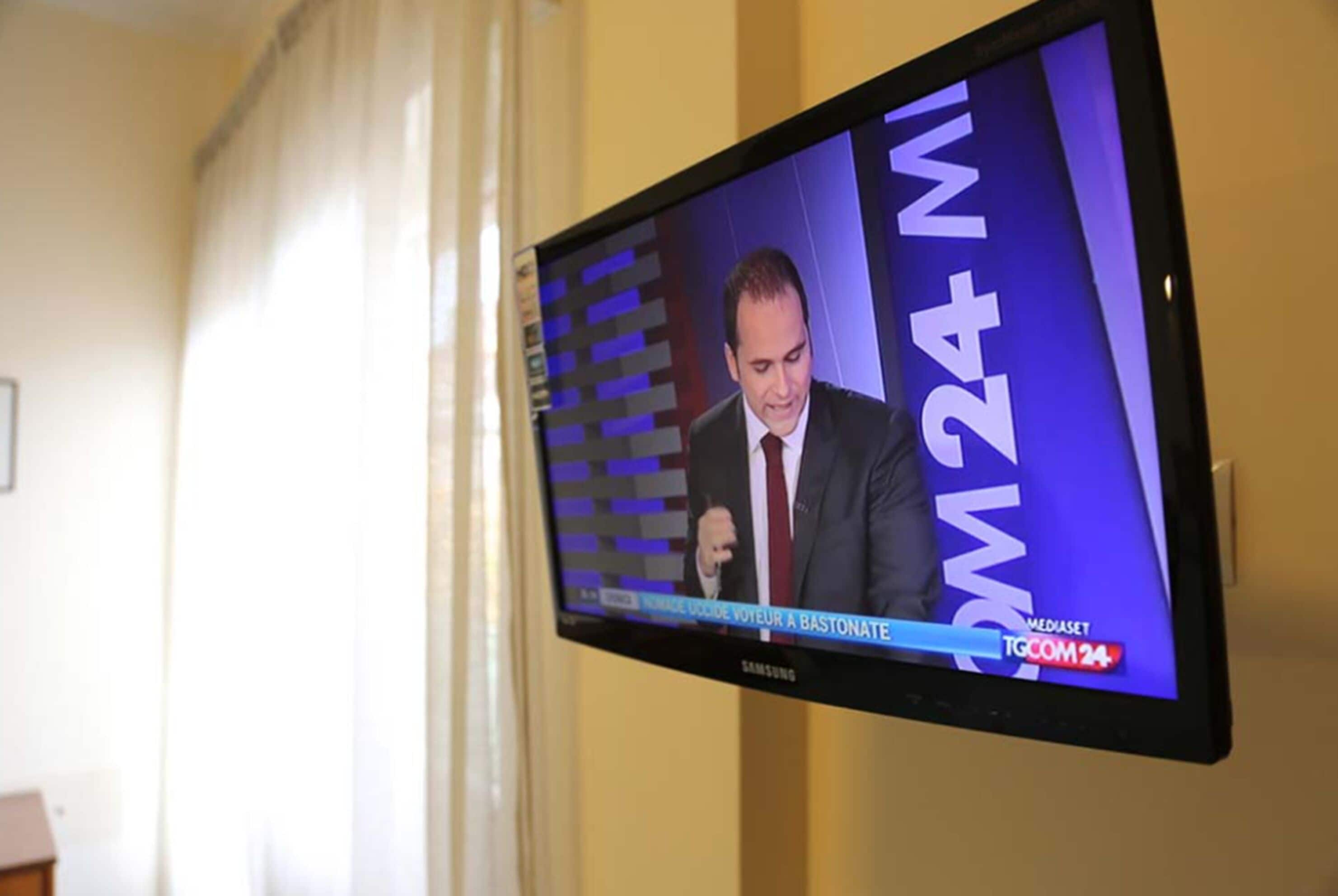A television displaying a news broadcast.
