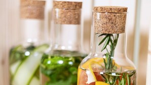 Three glass bottles with cork stoppers, filled with water, lemon slices, rosemary, and a slice of meat. - ibis Styles Dunarea Galati (Galati)