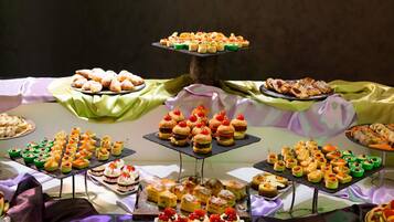 A buffet table with various food items arranged on multiple serving boards.