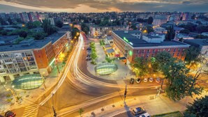 An aerial view of a cityscape with a roundabout, buildings, and vehicles. - ibis Styles Dunarea Galati (Galati)