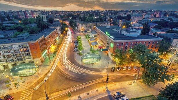 An aerial view of a cityscape with a roundabout, buildings, and vehicles. - ibis Styles Dunarea Galati (Galati)