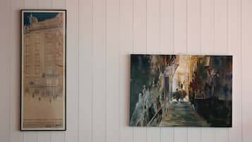 Two framed artworks on a white wall.