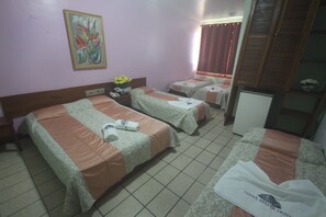 A hotel room with two beds, a small table, a nightstand, a wall-mounted TV, and a painting. - Hotel Terra Mater (Porto Seguro)