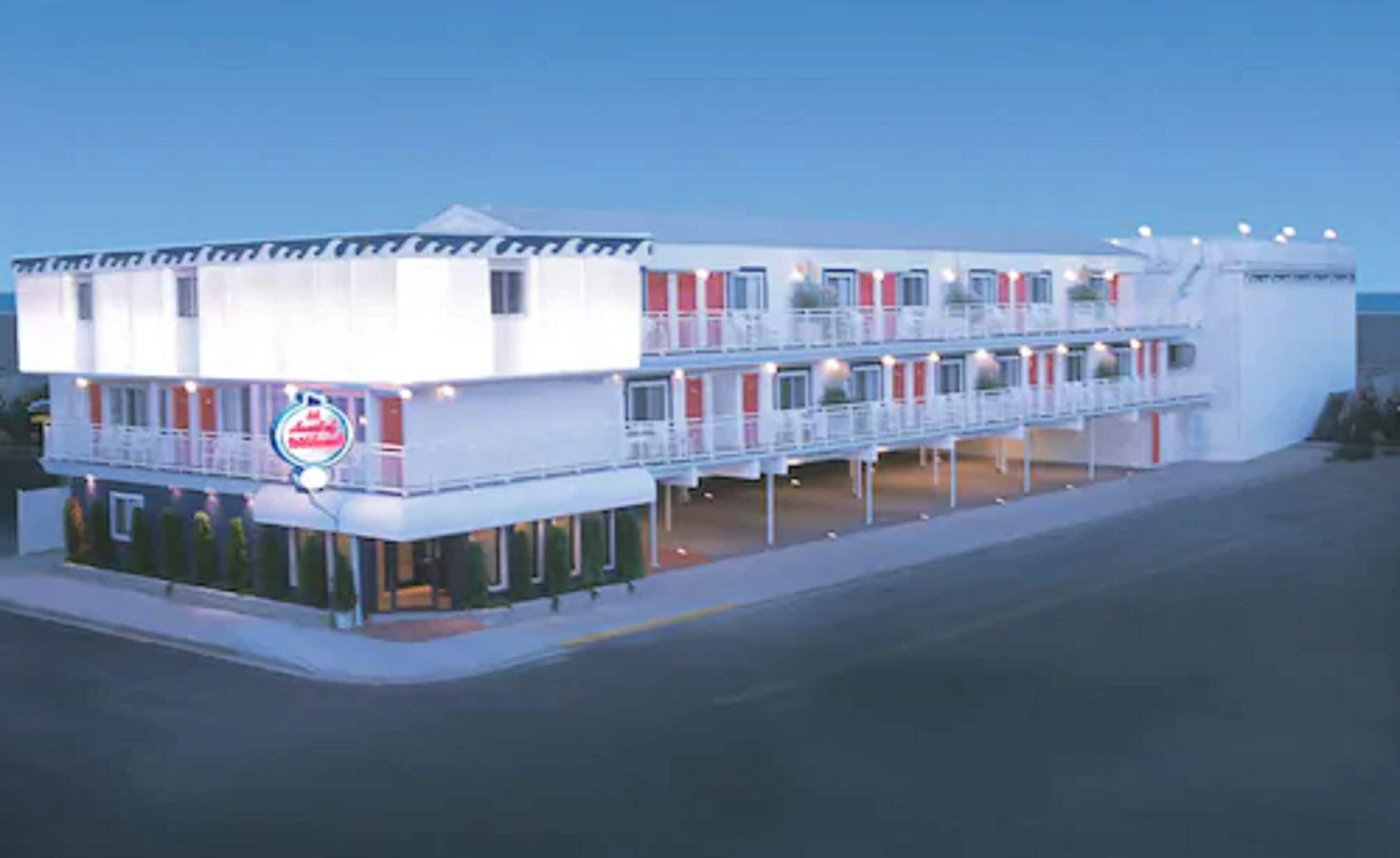 A multi-story hotel with a prominent sign on the ground floor.