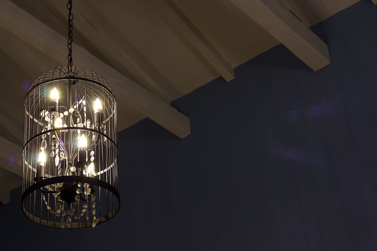 A chandelier with multiple bulbs hanging from a metal frame.