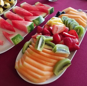 A table with various fruits arranged in plates. - Greenville Inn at Moosehead Lake (Greenville)