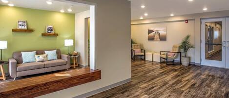 A modern living room with a sofa, coffee table, and decorative items.