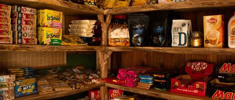 A pantry stocked with various food items and snacks.