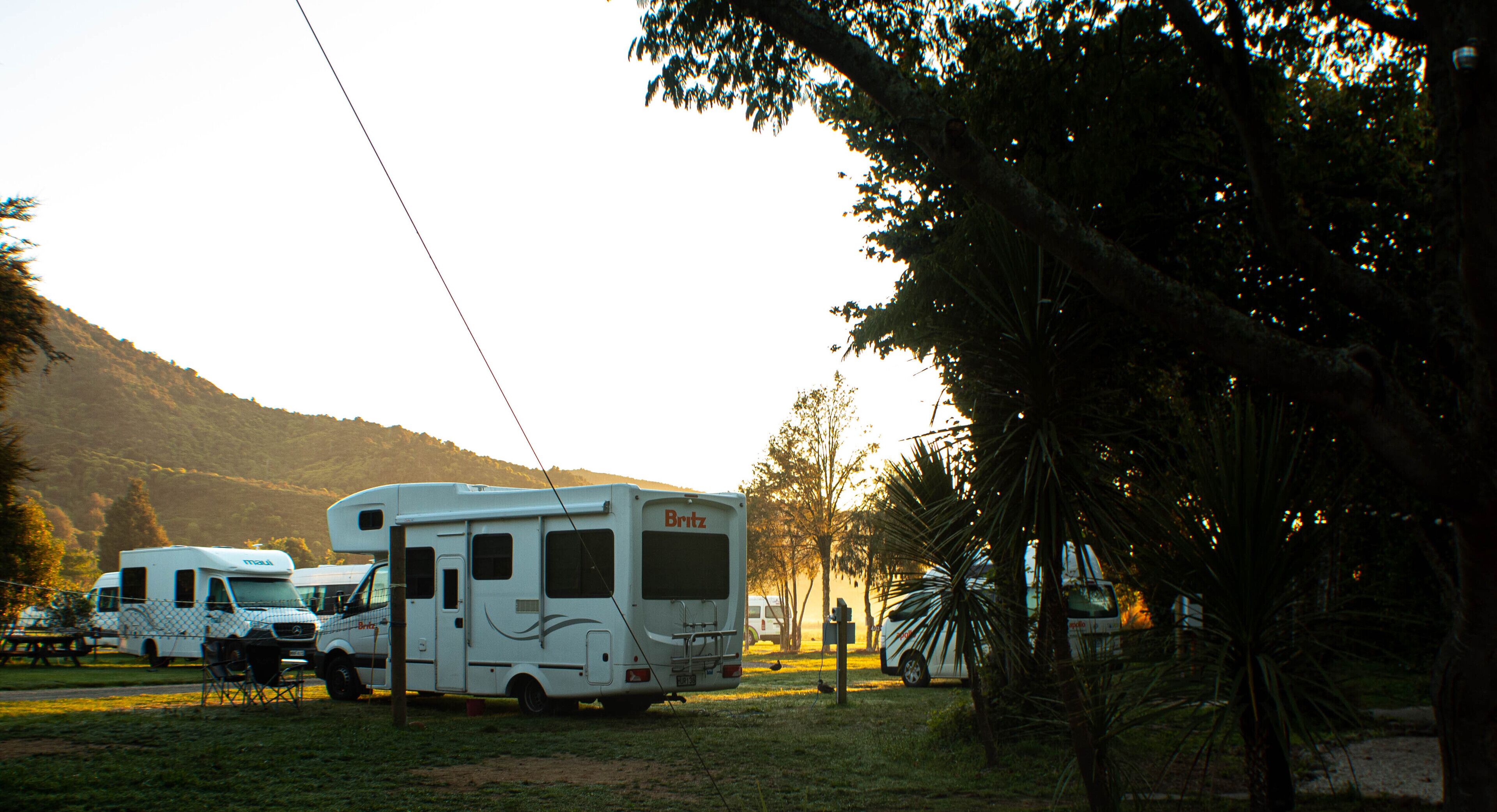 A campsite with RVs and a picnic table.