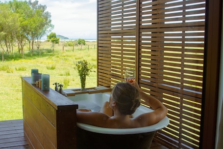 Premium House | Deep soaking bathtub. The Barn Cabins & Camp