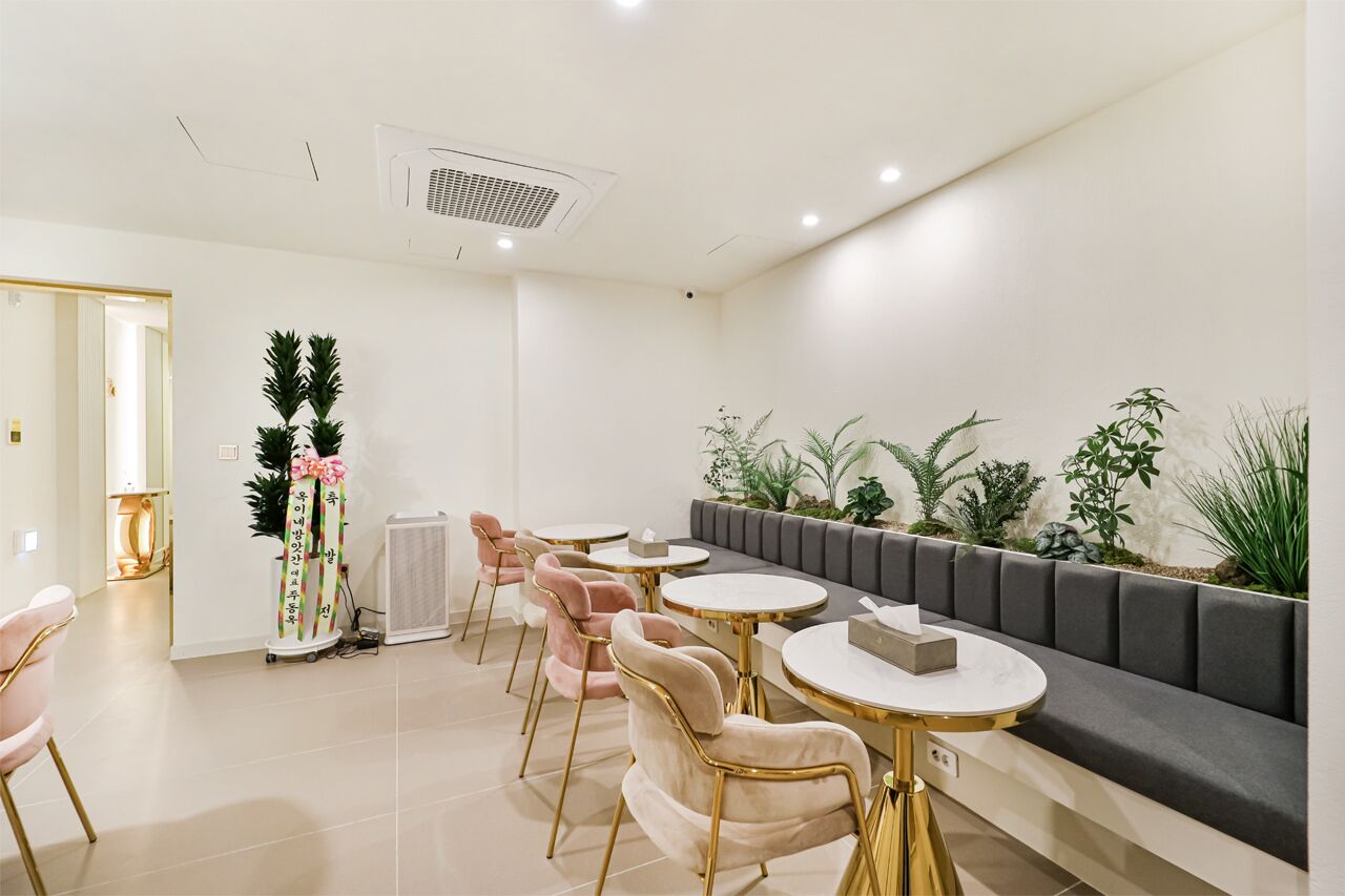 A modern waiting area with a sofa, chairs, and tables.