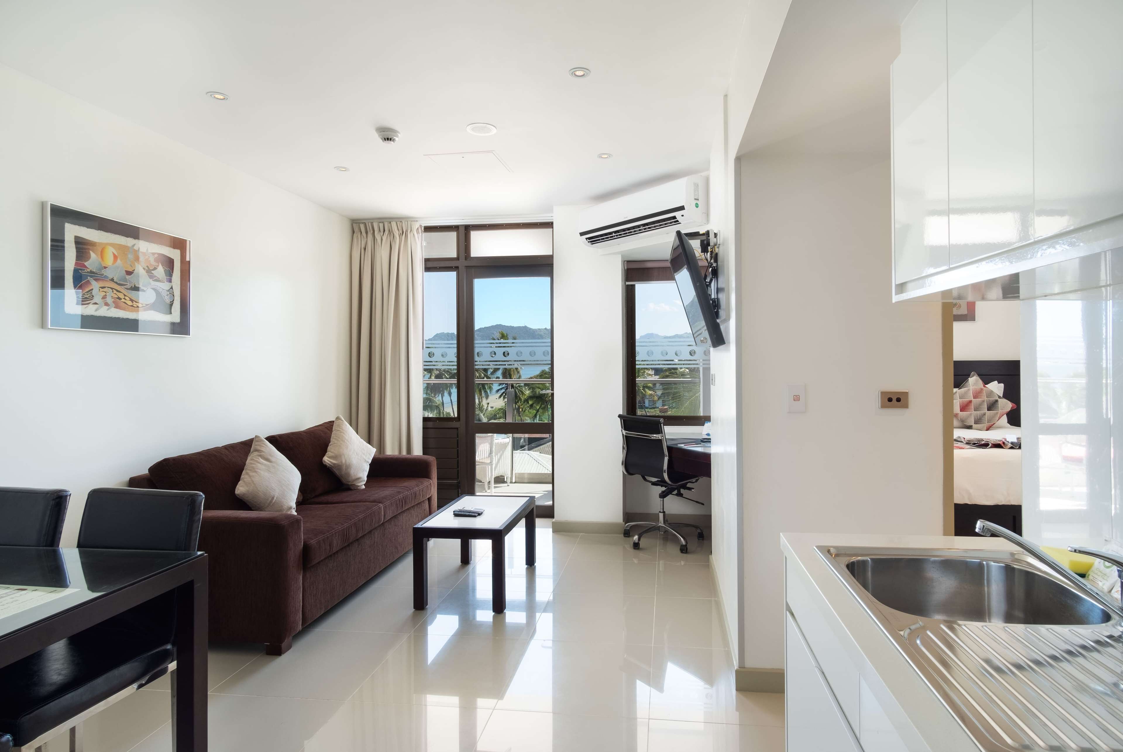 suite, multiple beds, non smoking, partial ocean view | living area | 42-inch flat-screen tv with satellite channels, tv, mp3 dock