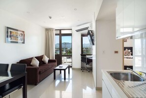 1 King Bed, 2 Single Beds, 2-Bedroom Suite, Partial Ocean View, Non-Smoking | Living area | 42-inch flat-screen TV with satellite channels, TV, MP3 dock