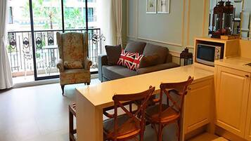 1 Bedroom Pool View | Living area | Flat-screen TV