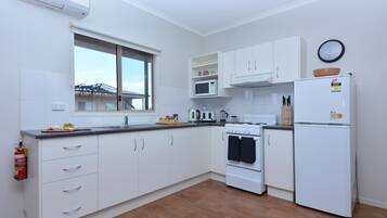 Superior 2 Bedroom Cabin (1 King and 2 Single Beds) | Private kitchen | Full-size fridge, microwave, toaster, cookware/dishes/utensils