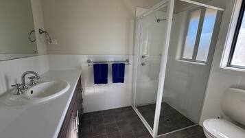 A bathroom with a bathtub, a shower, and a toilet.