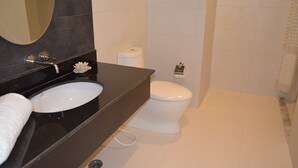 A bathroom with a black sink, white toilet, and a mirror. - Malibu Hua Hin by Puppap (Hua Hin)