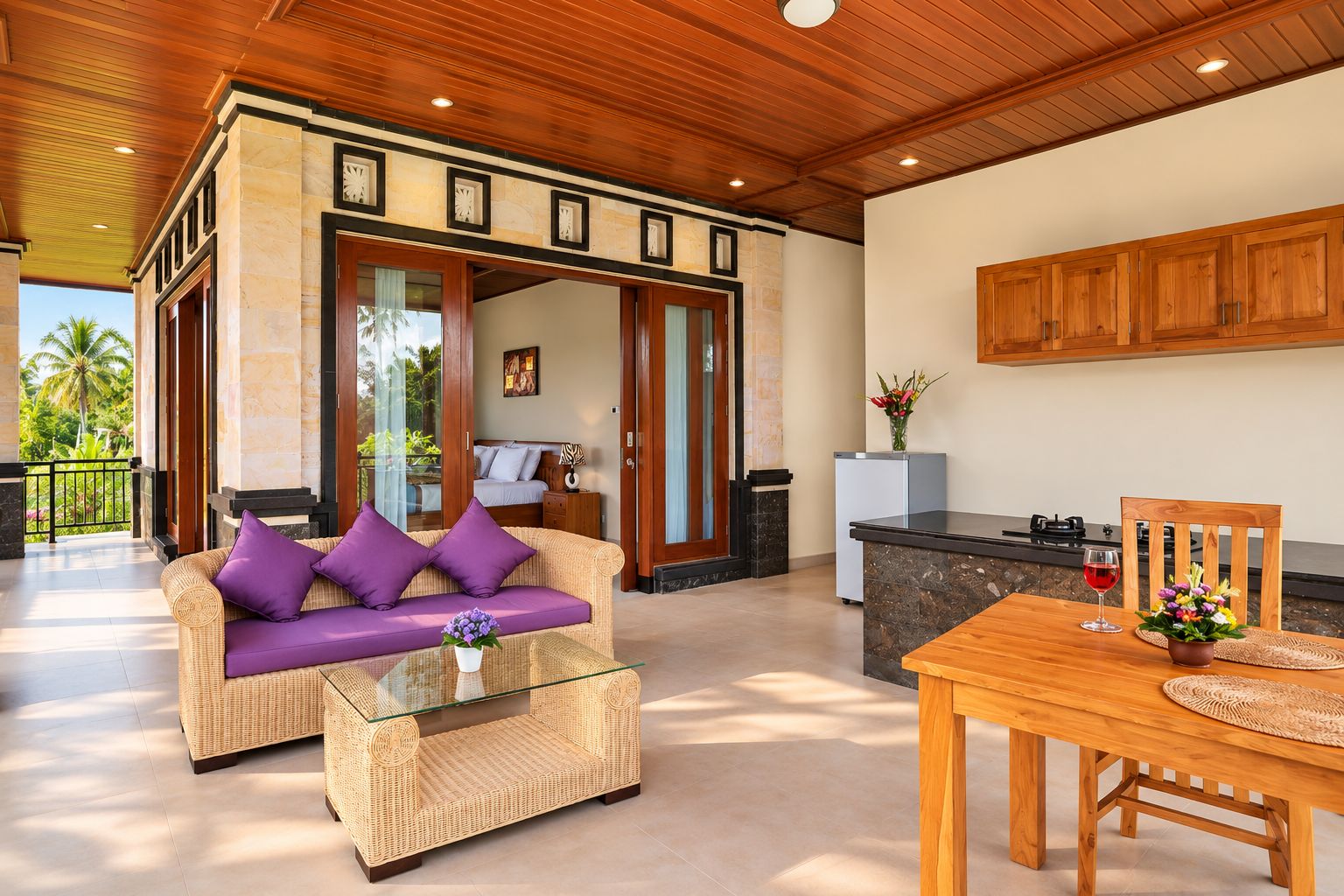 A spacious living area with a sofa, a glass coffee table, and a dining table with chairs.