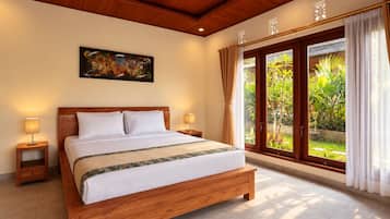 A hotel room with a large bed, wooden headboard, two bedside tables with lamps, a large window with curtains, and a painting on the wall.