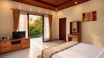 A bedroom with a bed, a TV, a wooden dresser, a mirror, and a door leading to a pool area.