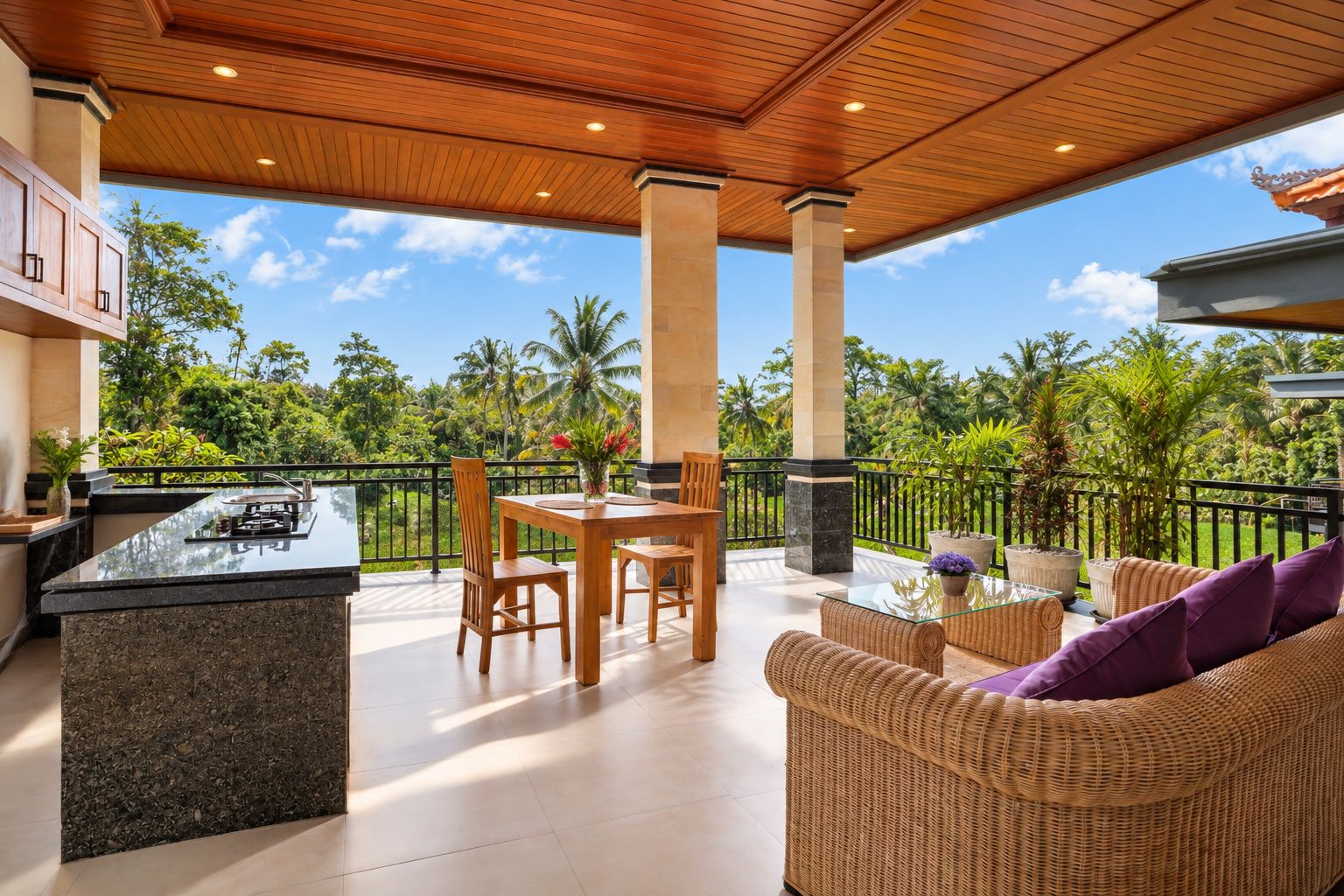 An outdoor patio with a dining area, a wicker sofa, and a view of lush greenery.