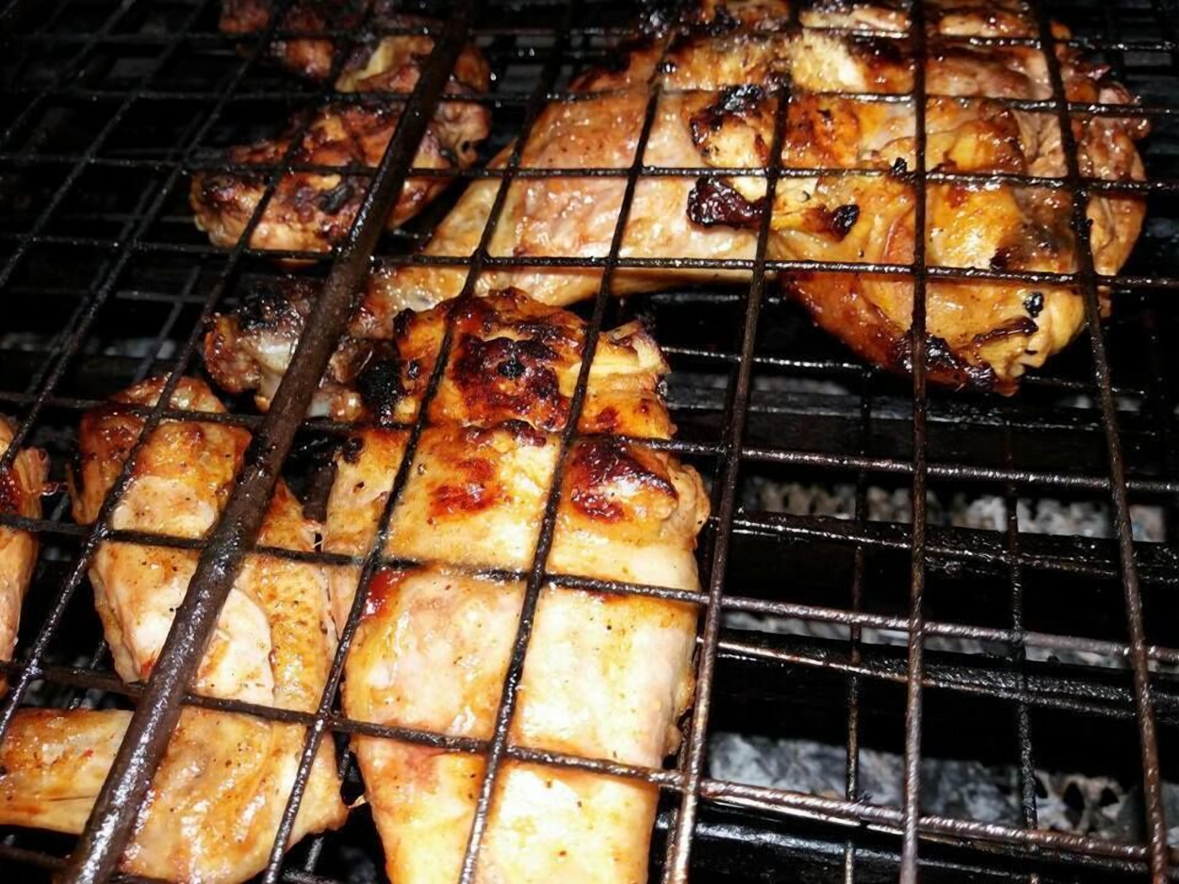 Grilled chicken on a grill.