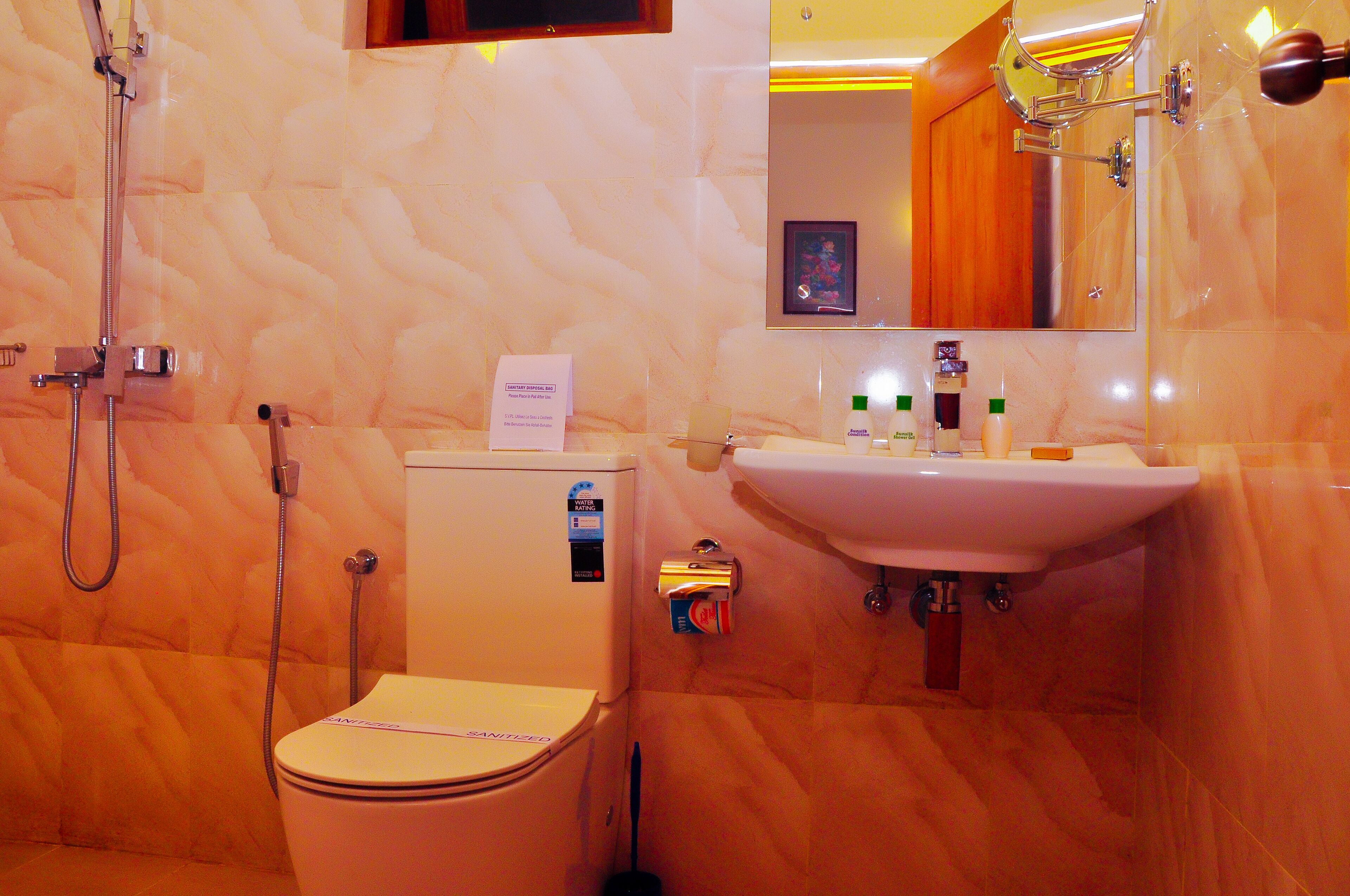 A bathroom with a toilet, a sink, and a shower.