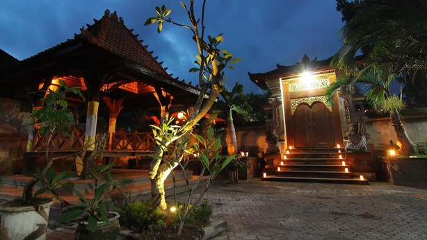 A traditional building with a tiled roof and a well-lit entrance.