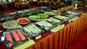 A buffet with various food items and utensils. - Kıvrak Hotel (Antalya)