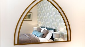 A bedroom with a bed, pillows, and a nightstand with a lamp. - Black Burn Lodge (Newcastleton)
