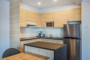 Suite Junior, 1 très grand lit et 1 canapé-lit, coin cuisine | Cuisine privée | Réfrigérateur, micro-ondes dans l'espace commun, cafetière/bouilloire