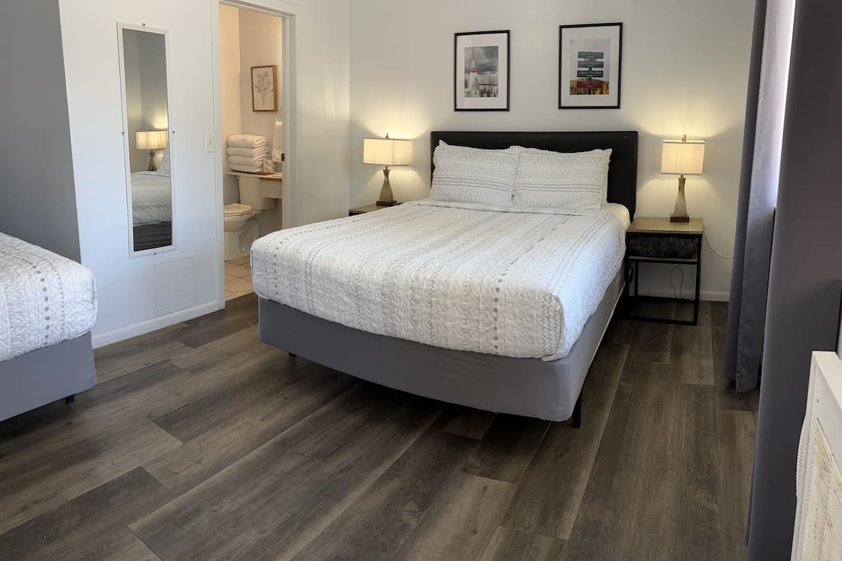 Economy Room, 2 Queen Beds | Living area | 65-inch Smart TV with cable channels, streaming services
