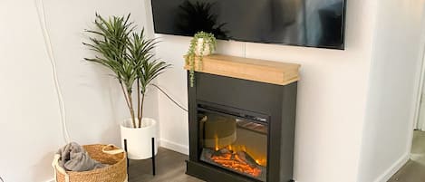 Apartment | Living area | 65-inch Smart TV with cable channels, streaming services